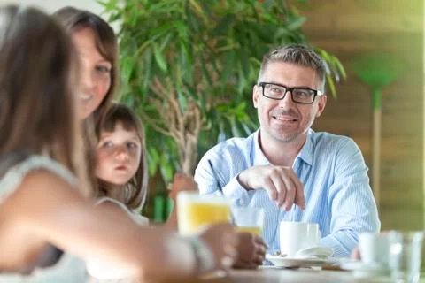 Family talking at table Stock Photos