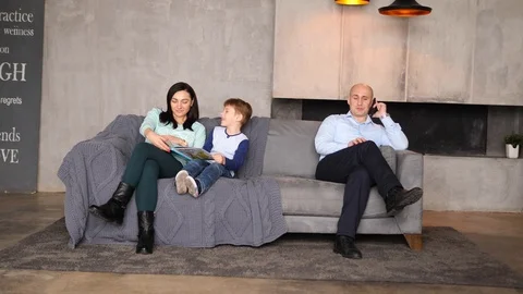 Family of three on the couch Video stock 89472166