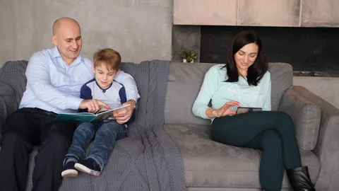 Family of three on the couch Video stock 89472743