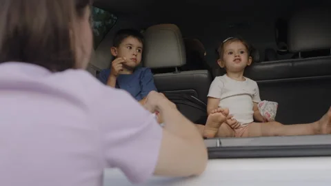Family of three having fun while taking a meal break during their car trip. Stock Footage 258852106