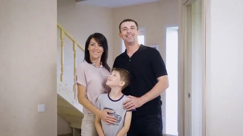 Family of three in new fresh house. Empty room and family full of plans Stock Footage