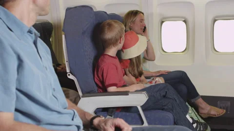 Family using cellphone on plane Stock Footage 67345495