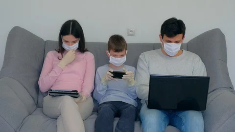 Family using gadgets at home isolation on coronavirus pandemic quarantine. Stock Footage 128986090