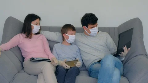 Family using gadgets at home isolation on coronavirus pandemic quarantine. Stock Footage 128986787