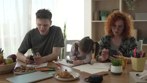 Family using smart phones while daughter is drawing Stock-Footage 333261572