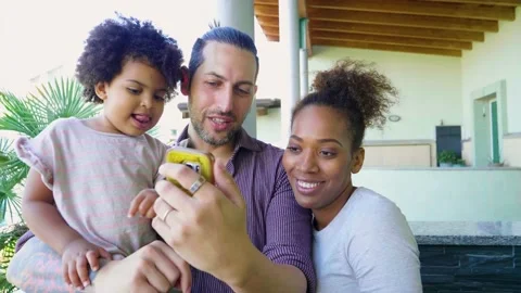 Family using smartphone on balcony Stock Footage 136524044