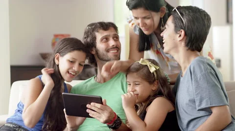 Family using a tablet computer in living room Stock Footage