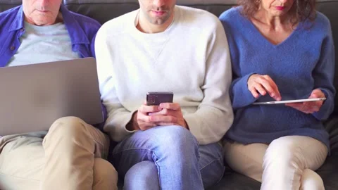 Family using technology devices while sitting together Stock Footage 266717831