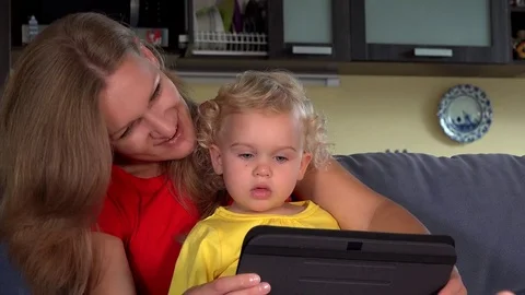 Family video conversation on tablet computer. Mom and daughter call dad Stock Footage 82196965