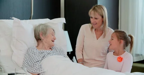 Family Visit To Grandmother In Hospital Bed Stock Footage