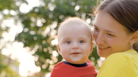 Family Mom hugs her baby in park Stock Video Pond5