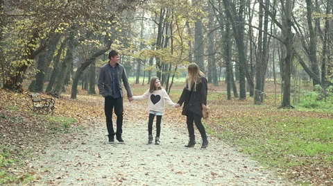 Family walking in the park holding hands Stock Footage 59553668