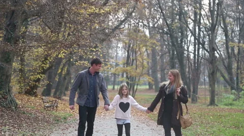 Family walking in the park holding hands Stock Footage 59553680
