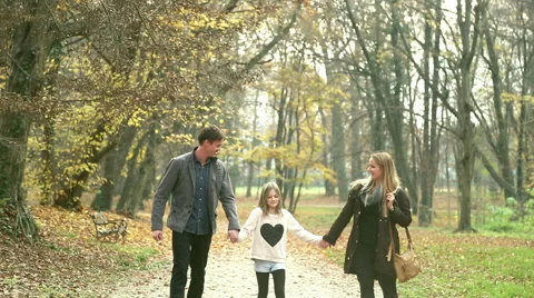 Family walking in the park holding hands Stock Footage 59553682