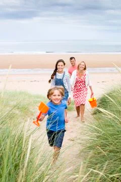 Family walking up the sand dunes Фото