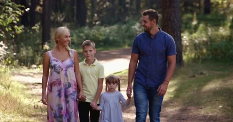 Family walking in the woods Stock Footage