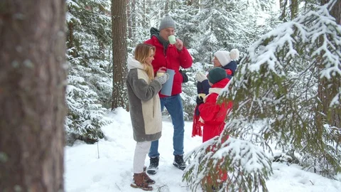 The family warms up with warm tea in the winter Video stock 129098247