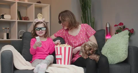 Family watching a 3D movie together with 3D glasses and eating popcorn. Stock Footage