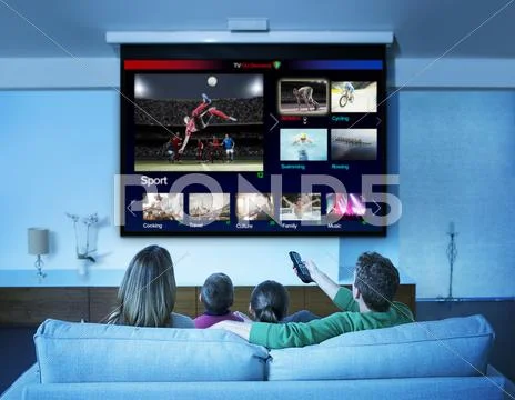 Family watching television in living room Stock Photos