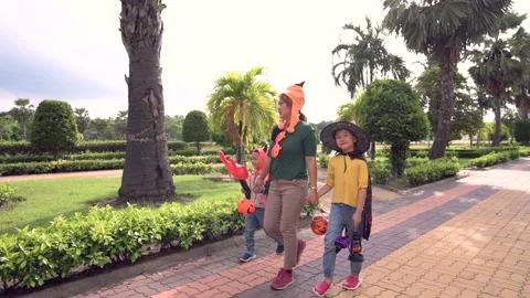 The familyhood with the Halloween costume playing in the park. Stock Footage