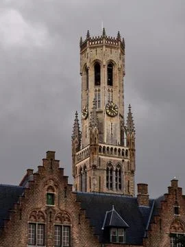 Famous Belfry Tower under dramatic sky, Bruges, Belgium Stock Photos