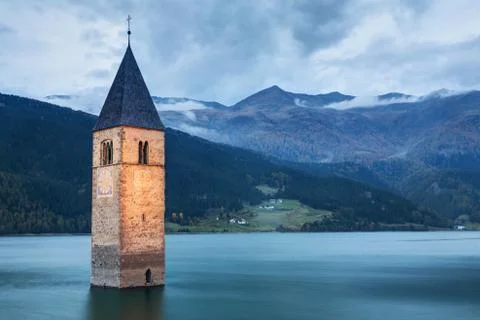 Famous Bell Tower of the Sunken church in Resia Lake, Italy. Stock Photos