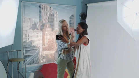 Famous black model making selfie with make-up artist while she applying makeup Stock Footage 153511420