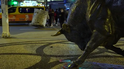 Famous bull statue in Kadikoy and people walking at night Stock Footage