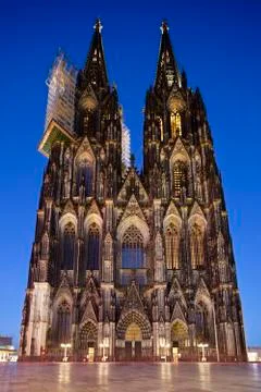 The famous Cologne Cathedral at night with deep blue sky, front portal view.  Stock Photos