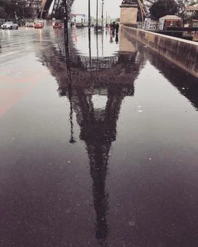 The famous Eiffel Tower reflected in the rain. Stock Photos
