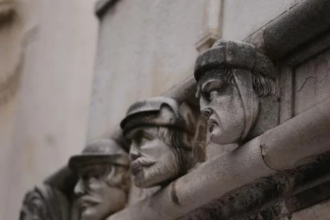 Famous faces on the side protal of Sibenik cathedral. Stock Photos