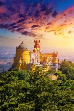 Famous historic Pena palace part of cultural site of Sintra against sunset sk Stock Photos