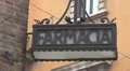 Famous Italian pharmacy farmacia sign hang exterior wall vintage banner shop day HD Footage