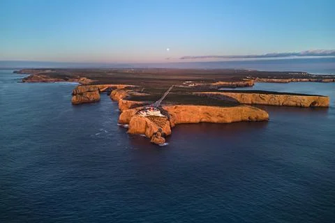 Famous lighthouse Farol do Cabo de Sao Vicente in warm sunset light Stock Photos