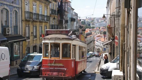 Famous Lisbon Trams Driving Steep Hills on Narrow City Streets Stock Footage 118158929