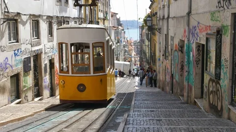 Famous Lisbon Trams Driving Steep Hills on Narrow City Streets Stock Footage 118158967