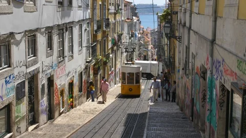 Famous Lisbon Trams Driving Steep Hills on Narrow City Streets Stock Footage 118159042