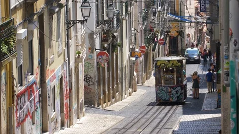 Famous Lisbon Trams Driving Steep Hills on Narrow City Streets Stock Footage 118159094
