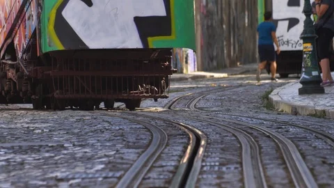Famous Lisbon Trams Driving Steep Hills on Narrow City Streets Stock Footage 118159437