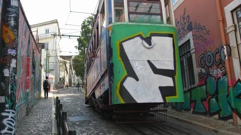 Famous Lisbon Trams Driving Steep Hills on Narrow City Streets Stock Footage 118159522