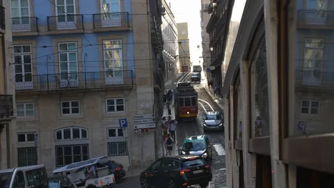 Famous Lisbon Trams Driving Steep Hills on Narrow City Streets Stock Footage 118159606