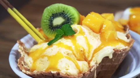 Famous Mango shaved ice with ice cream and custard. Tropical fruit cold sweet Stock Footage 59530638