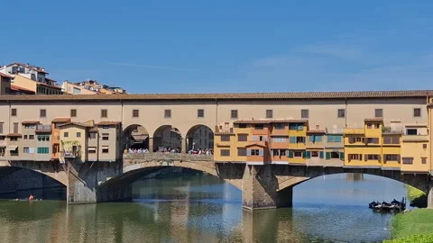 Famous medieval Ponte Vecchio Bridge reflecting in the Arno River Stock Footage 344669998