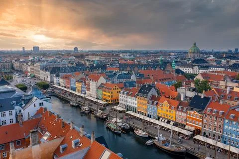 Famous Nyhavn pier with colorful buildings and boats in Copenhagen, Denmark. Stock Photos