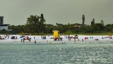 Famous Siesta Key beach with soft white sand in Sarasota, USA. Many people Stock Footage 221722833