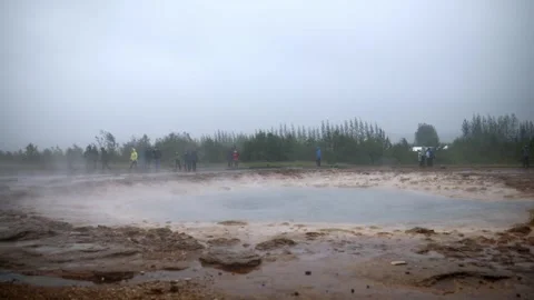 Famous Strokkur geyser between eruptions on a foggy rainy day in Iceland Stock Footage 298573641