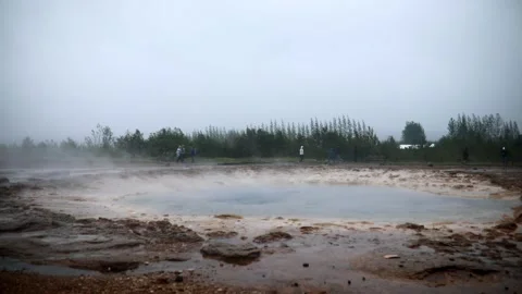 Famous Strokkur geyser between eruptions on a foggy rainy day in Iceland Stock Footage 298574893