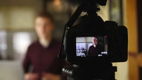 Famous young influencer excited while talking with the camera. Recording new Stock Footage 148084385