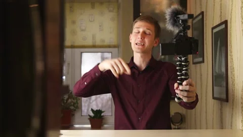 Famous young influencer excited while talking with the camera. Recording new Stock Footage 148084458