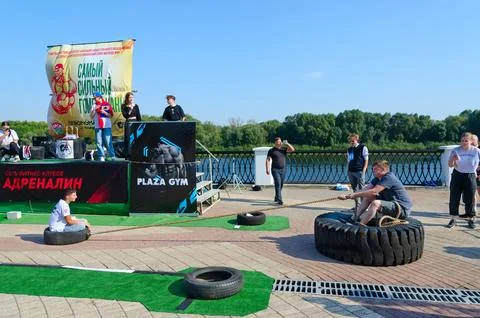 Fan competition to pull up load on rope during strength competition Stock Photos